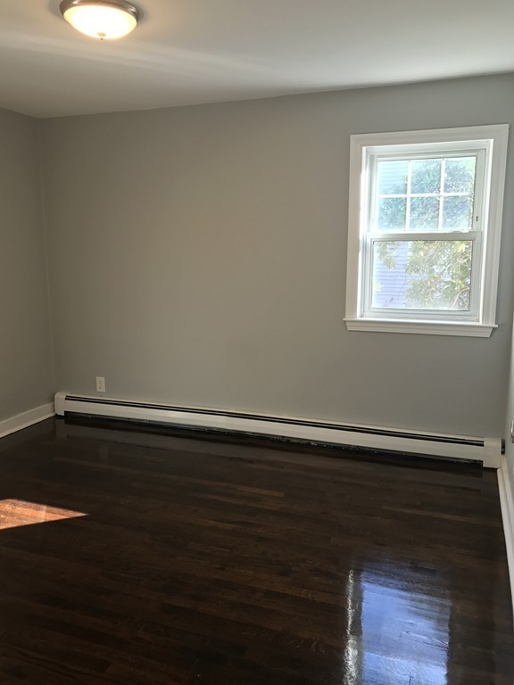 20 Selwyn Road Randolph, MA 02368 - Photo 10 of 20 an empty room with wooden floor and windows