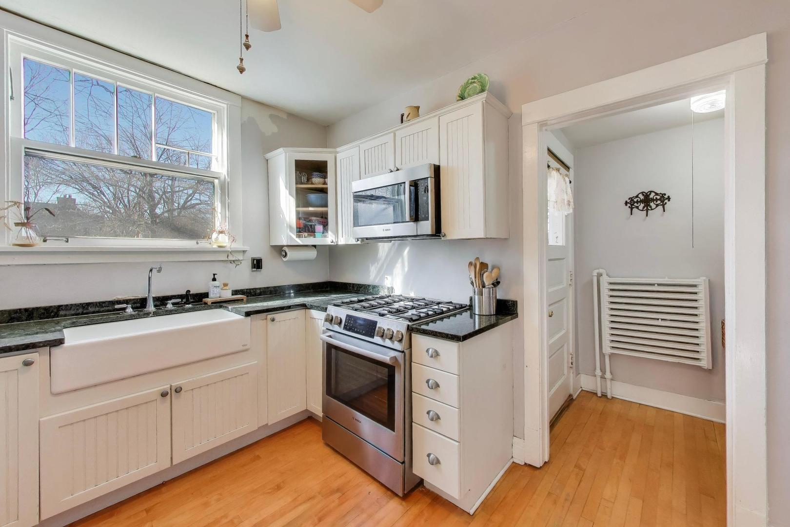 207 5th Street Wilmette, IL 60091 - Photo 11 of 30 a kitchen with stainless steel appliances granite countertop a stove and a sink