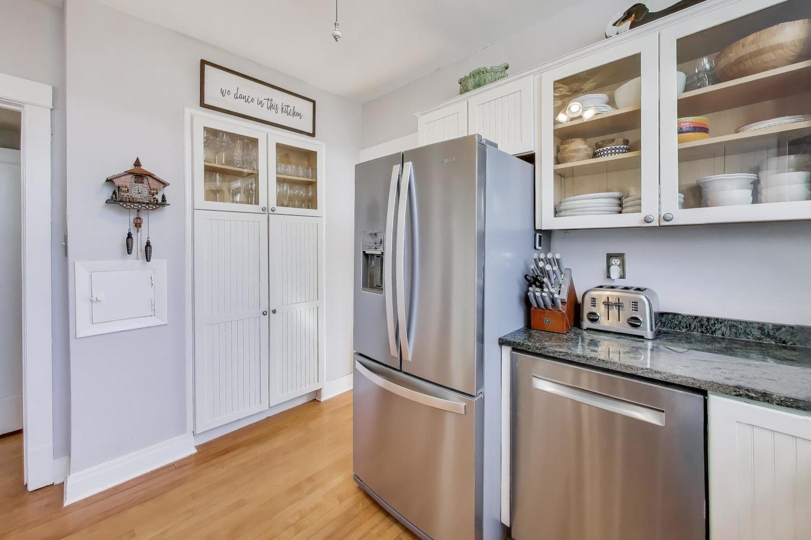 207 5th Street Wilmette, IL 60091 - Photo 12 of 30 a kitchen with stainless steel appliances granite countertop a refrigerator and a sink