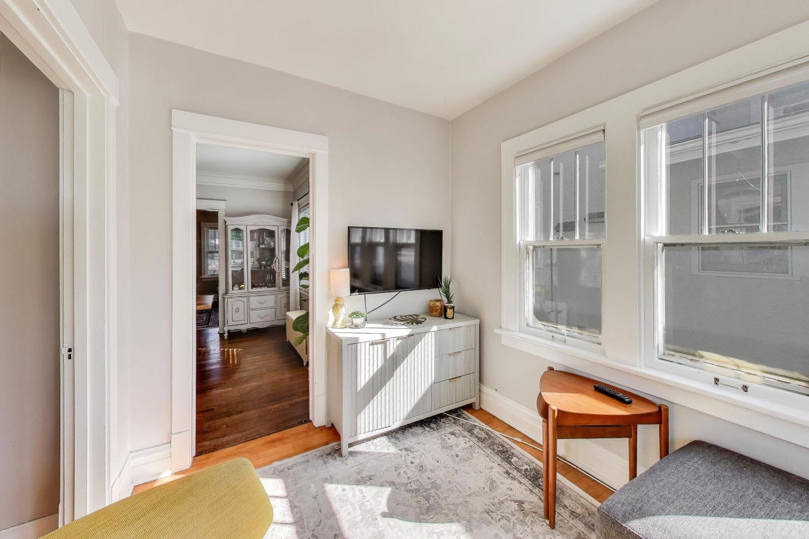 207 5th Street Wilmette, IL 60091 - Photo 14 of 30 a living room with furniture a flat screen tv and a window