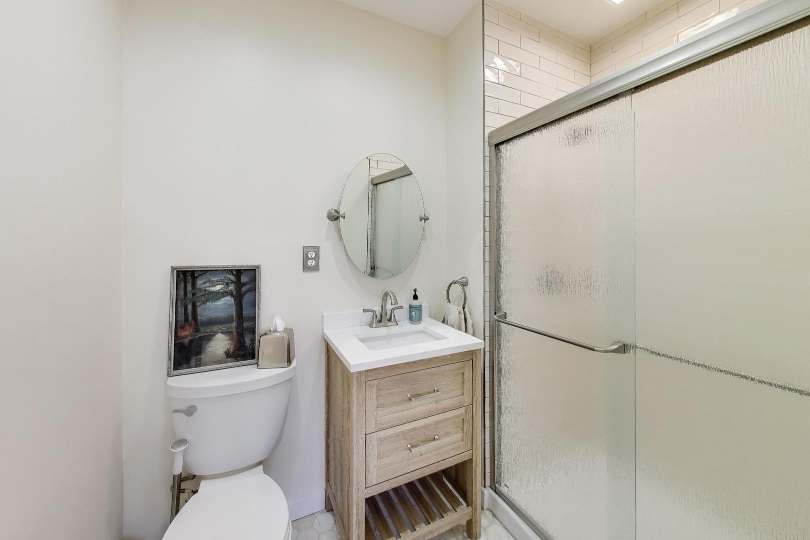 207 5th Street Wilmette, IL 60091 - Photo 17 of 30 a bathroom with a toilet sink and mirror