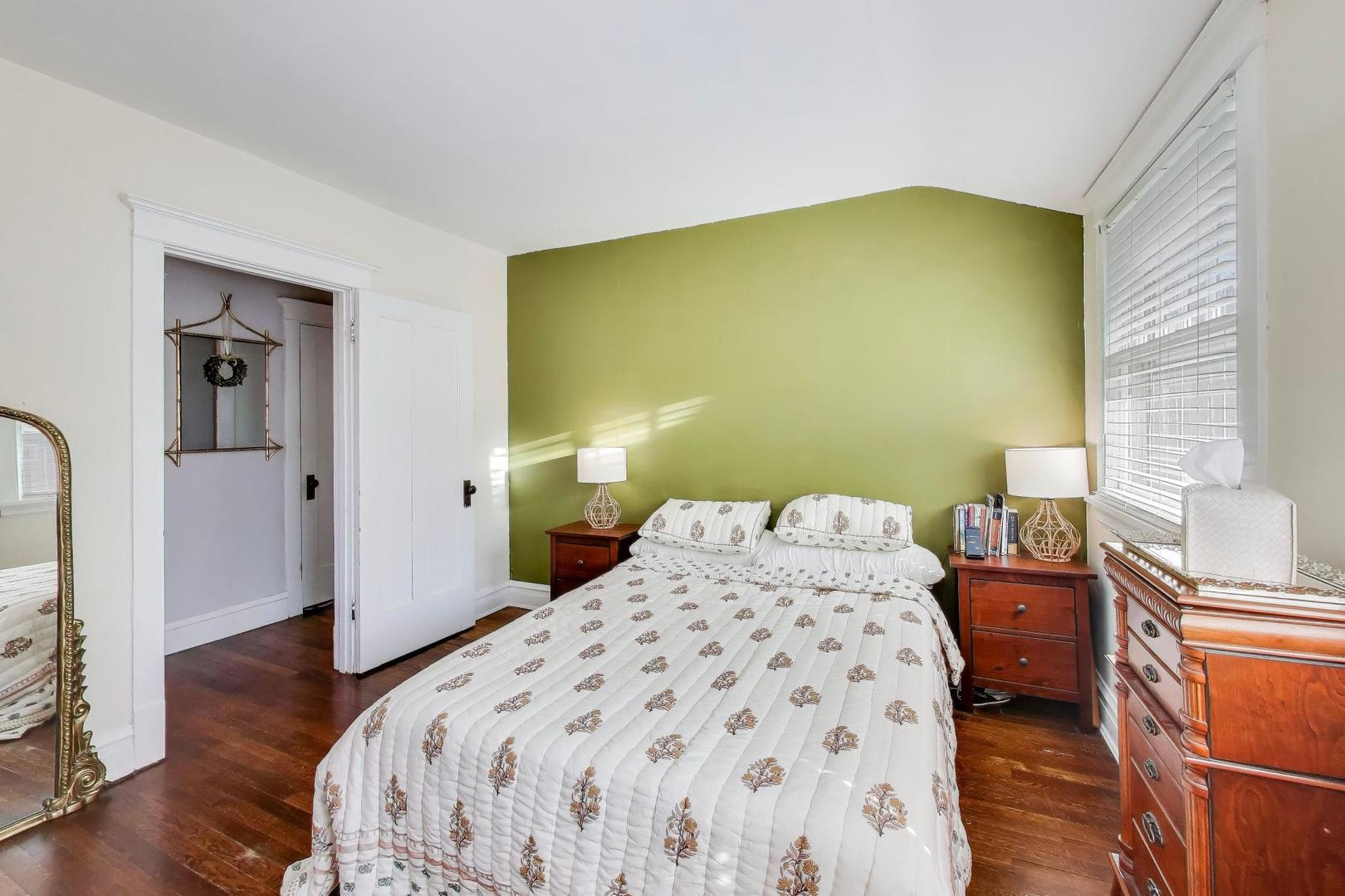 207 5th Street Wilmette, IL 60091 - Photo 19 of 30 a bedroom with a bed and wooden floor