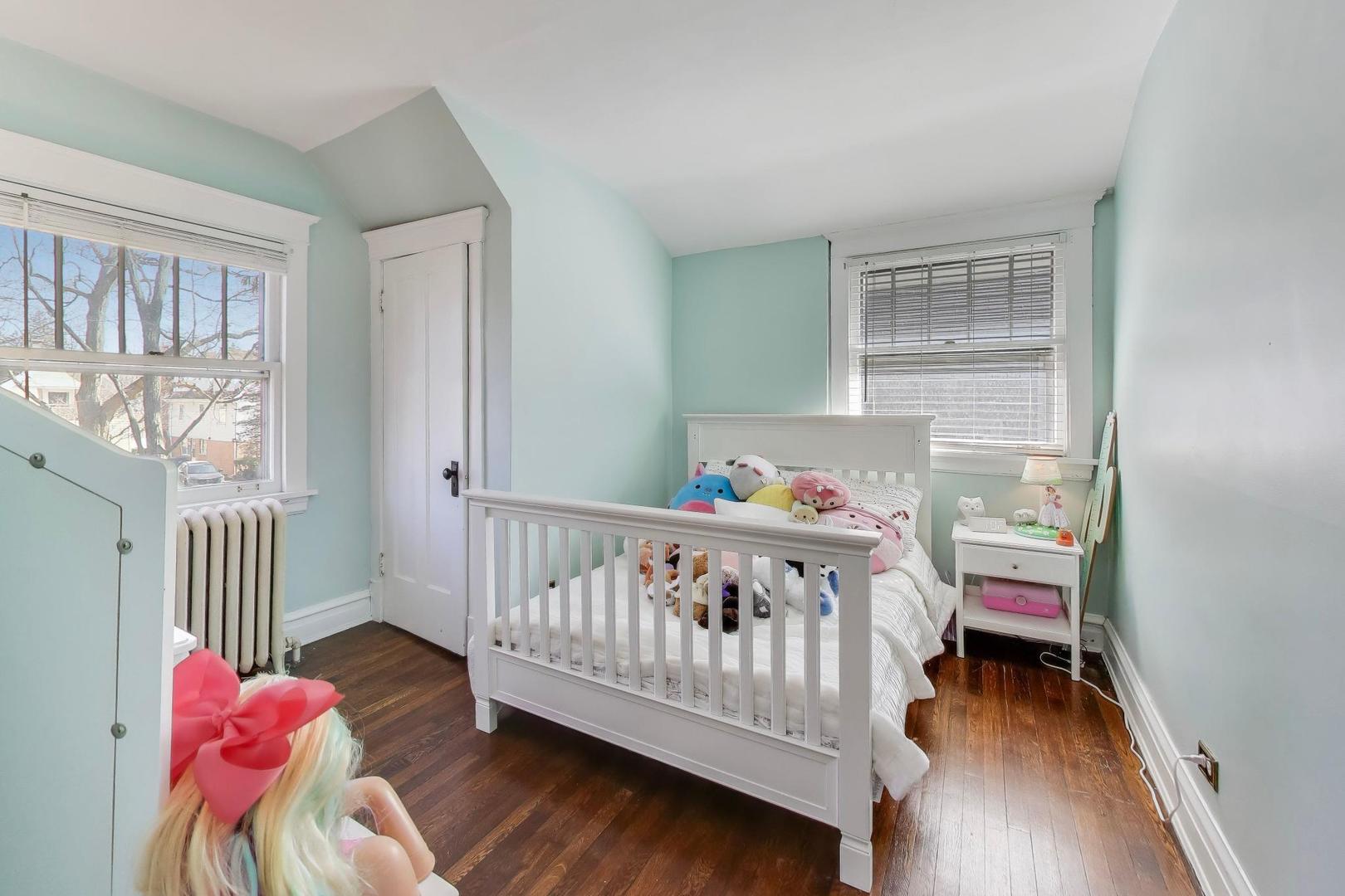 207 5th Street Wilmette, IL 60091 - Photo 26 of 30 a bedroom with a bed and a window