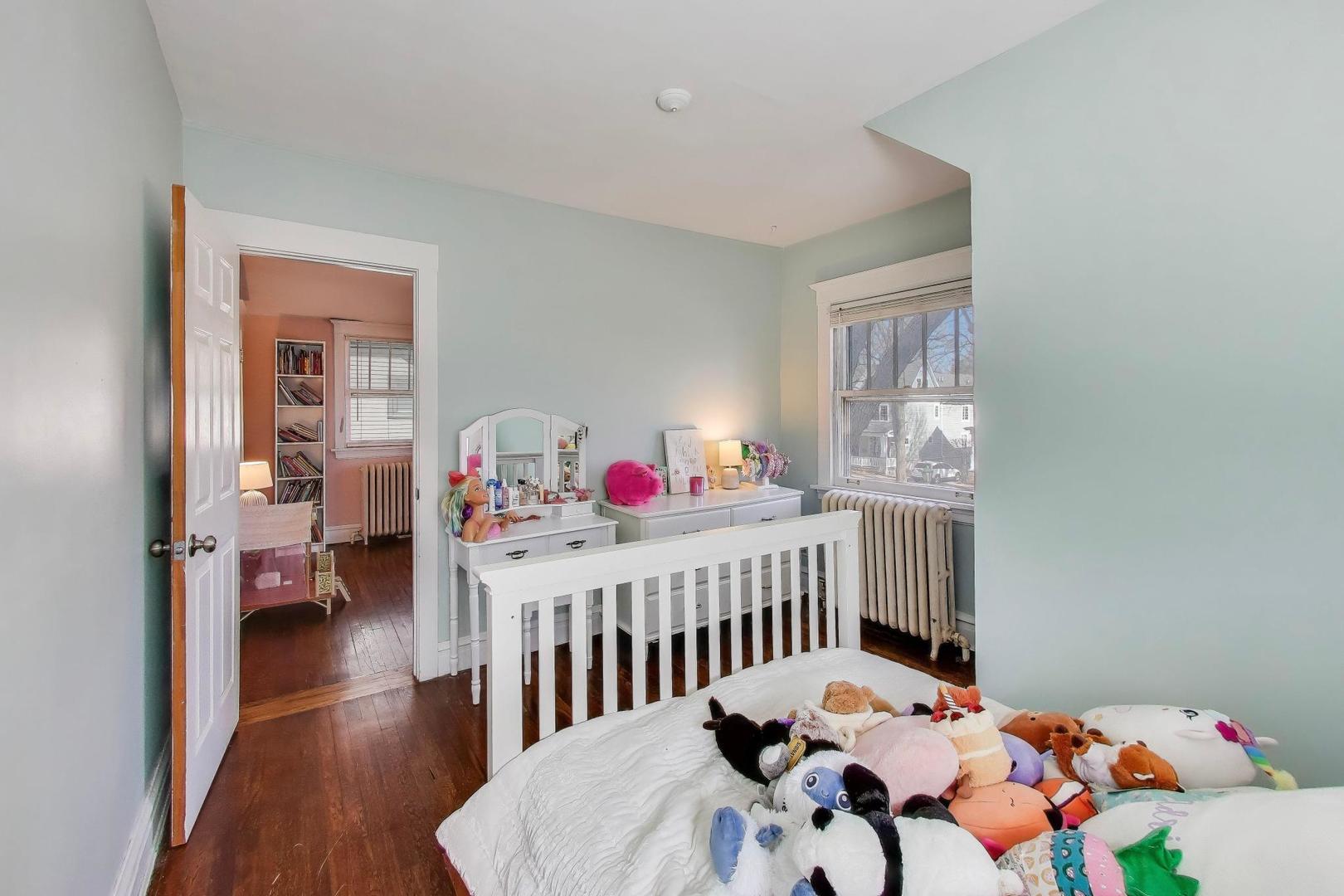 207 5th Street Wilmette, IL 60091 - Photo 27 of 30 a bedroom with furniture and a wooden floor
