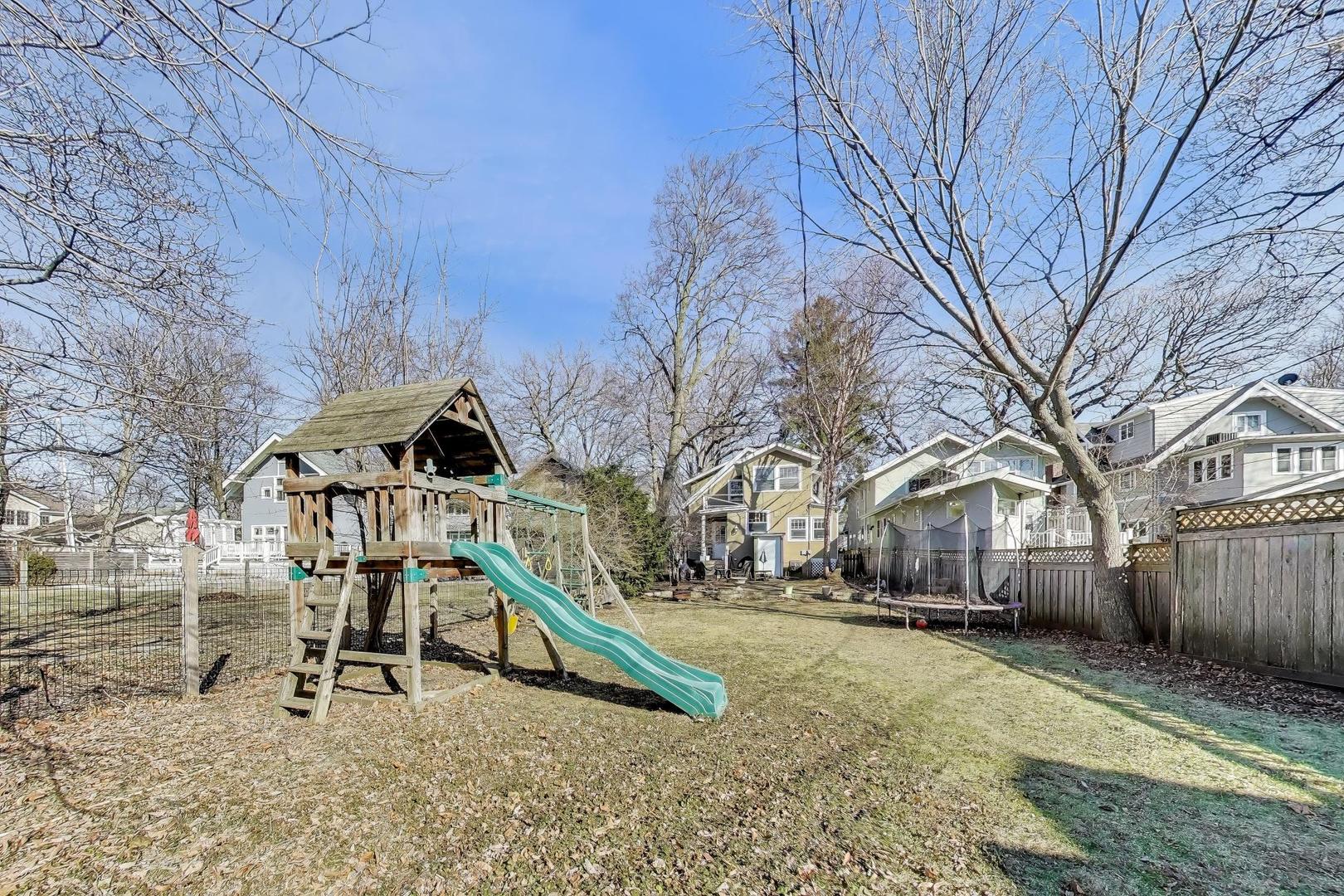 207 5th Street Wilmette, IL 60091 - Photo 29 of 30 a wooden bench sitting in front of a building