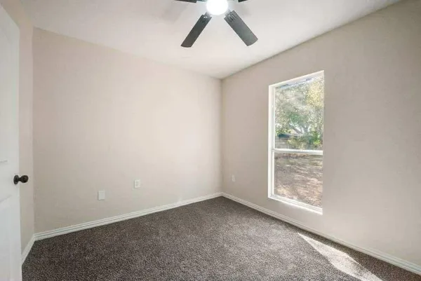 a view of room with window and ceiling fan