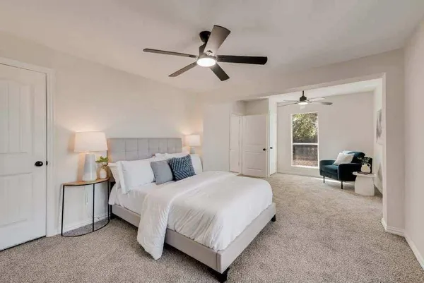 a bed room with a bed and a ceiling fan