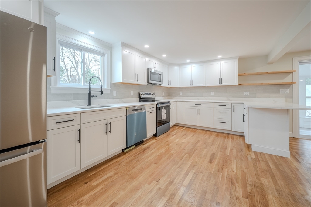 52 Bridge Street Billerica, MA 01821 - Photo 1 of 41 a kitchen with a sink wooden floor stainless steel appliances and cabinets