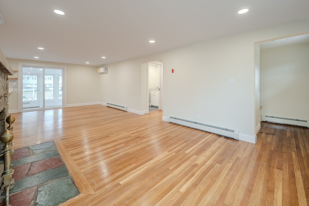 52 Bridge Street Billerica, MA 01821 - Photo 12 of 41 a view of an empty room with wooden floor and a window