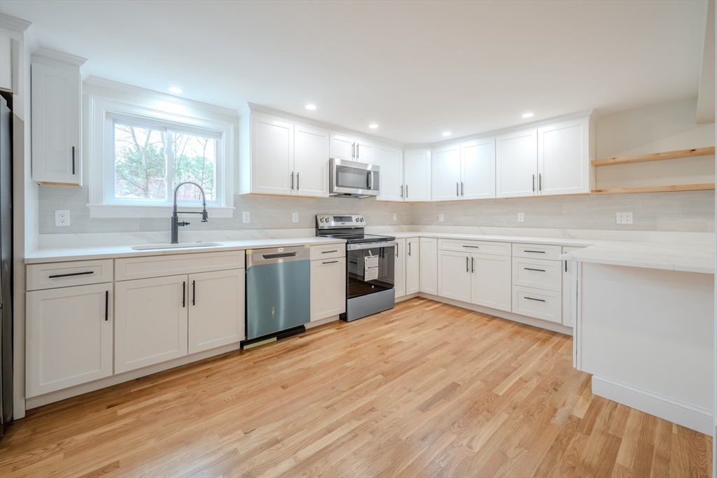 52 Bridge Street Billerica, MA 01821 - Photo 2 of 41 a kitchen with a sink cabinets and wooden floor
