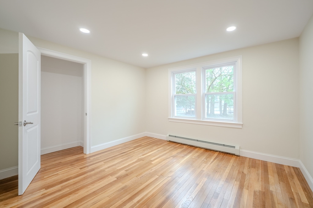 52 Bridge Street Billerica, MA 01821 - Photo 21 of 41 an empty room with wooden floor and windows