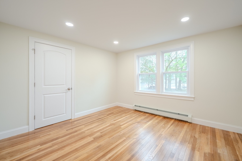 52 Bridge Street Billerica, MA 01821 - Photo 23 of 41 wooden floor in an empty room with a window