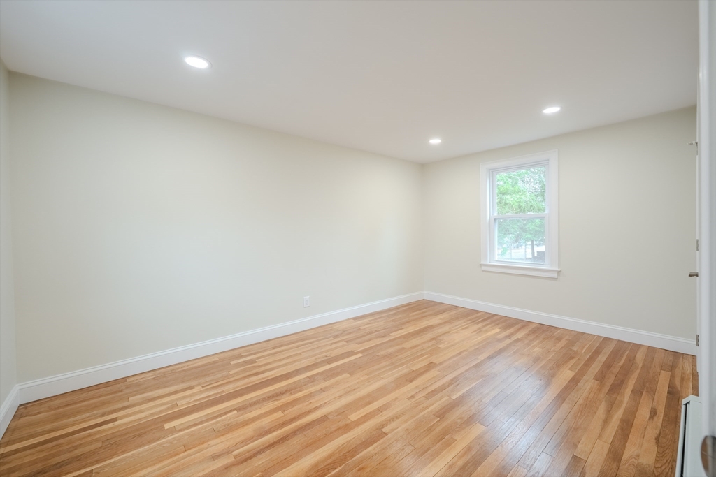 52 Bridge Street Billerica, MA 01821 - Photo 24 of 41 an empty room with wooden floor and windows