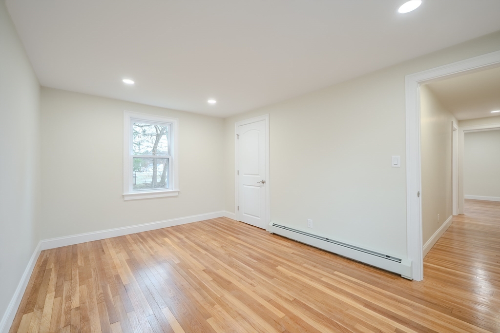 52 Bridge Street Billerica, MA 01821 - Photo 25 of 41 wooden floor in an empty room with a window