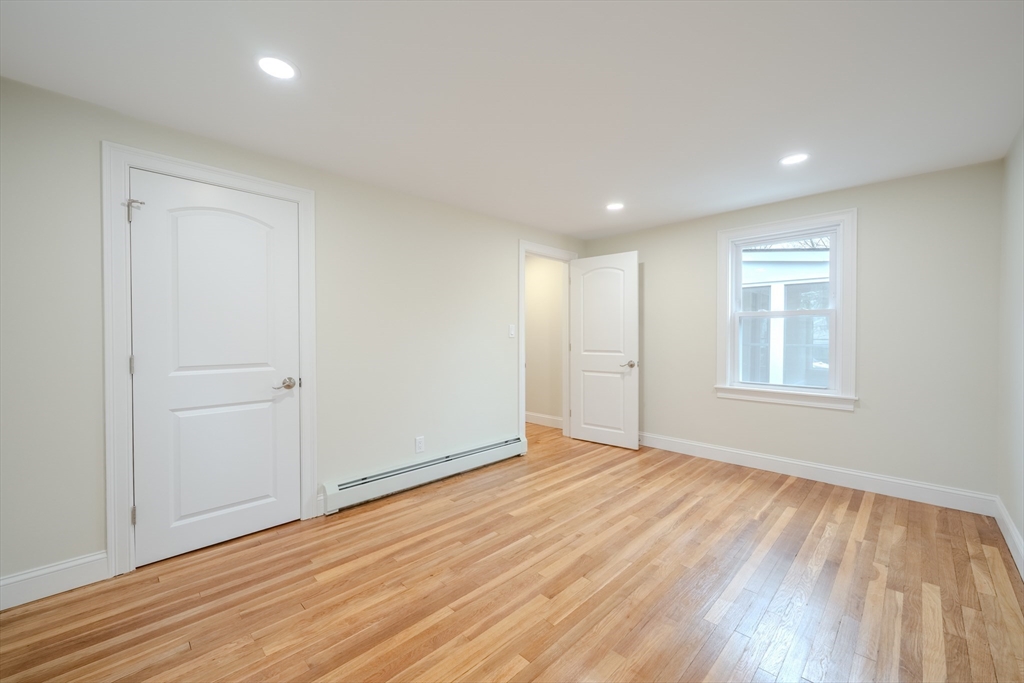 52 Bridge Street Billerica, MA 01821 - Photo 26 of 41 a view of an empty room with wooden floor and a window