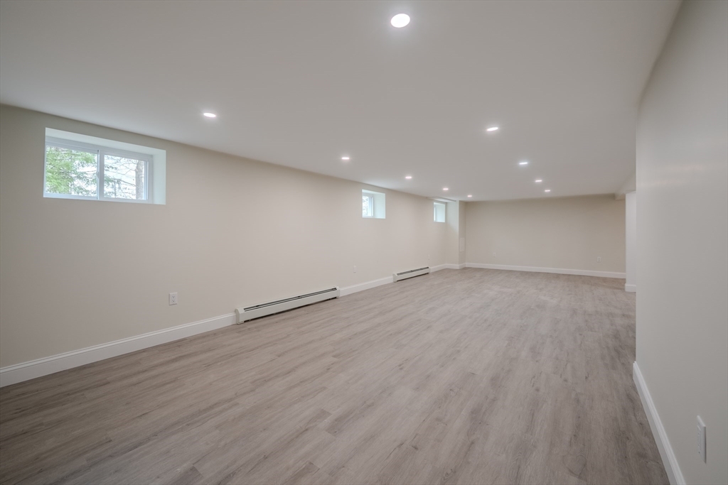 52 Bridge Street Billerica, MA 01821 - Photo 30 of 41 an empty room with wooden floor and windows