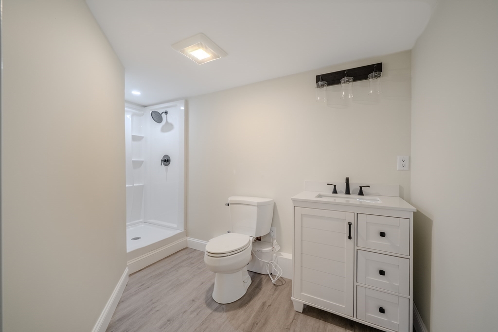 52 Bridge Street Billerica, MA 01821 - Photo 31 of 41 a bathroom with a toilet a sink and a mirror