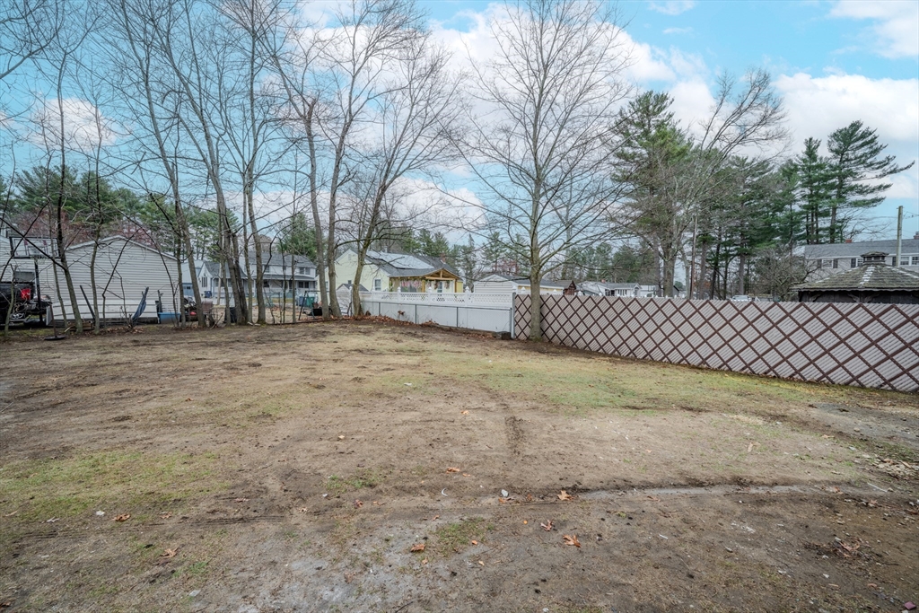 52 Bridge Street Billerica, MA 01821 - Photo 41 of 41 a view of a yard with wooden fence