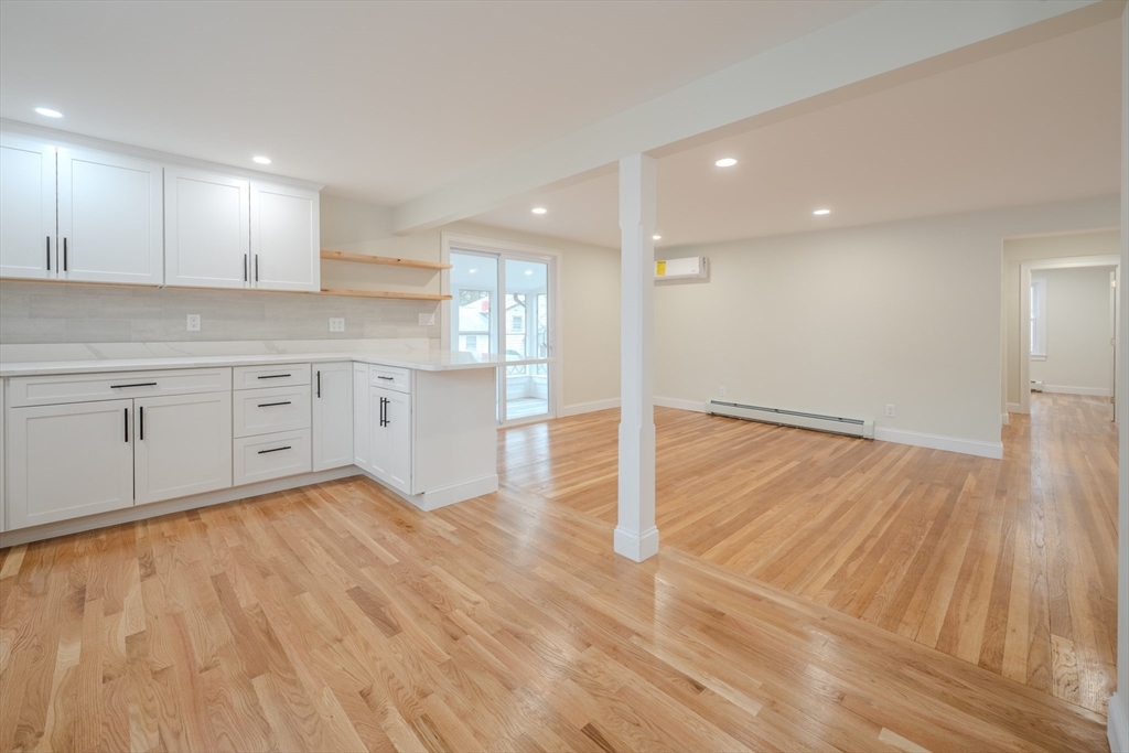 52 Bridge Street Billerica, MA 01821 - Photo 6 of 41 a large kitchen with cabinets and wooden floor