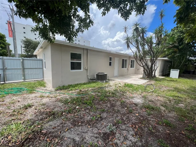 a house that has a tree in front of it
