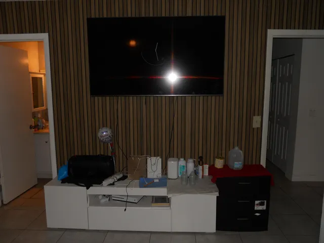 a bedroom with a bed and a tv on the dresser