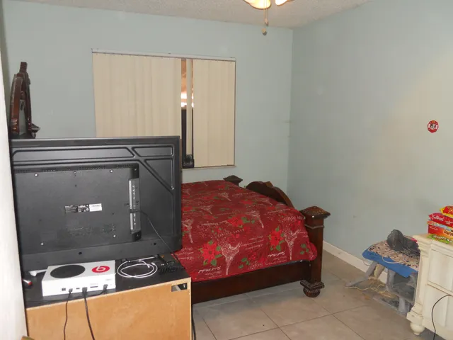 a bedroom with a bed and dresser