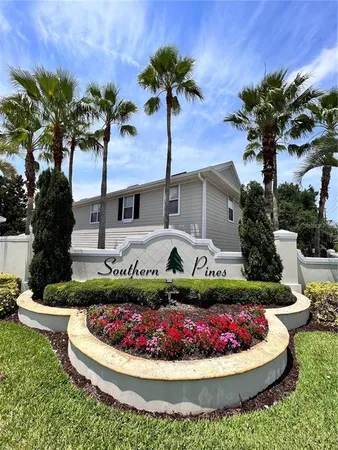 a front view of a house with a garden and swimming pool