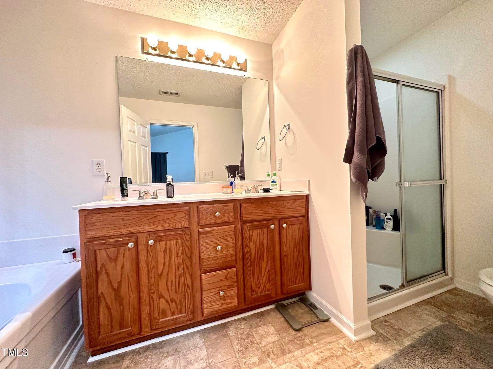114 Graystar Road Apex, NC 27502 - Photo 12 of 14 a bathroom with a sink vanity and mirror
