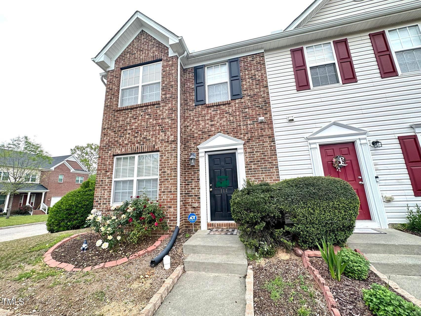 114 Graystar Road Apex, NC 27502 - Photo 2 of 14 a front view of a house with garden