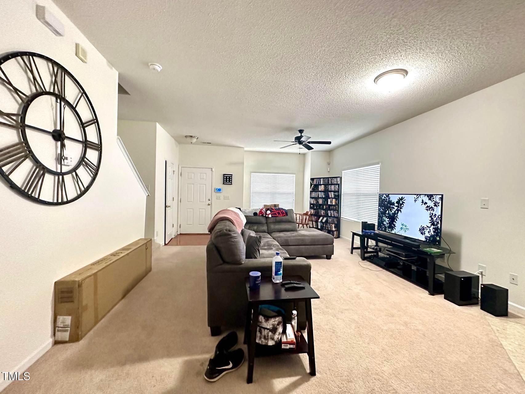 114 Graystar Road Apex, NC 27502 - Photo 3 of 14 a living room with furniture a window and a flat screen tv