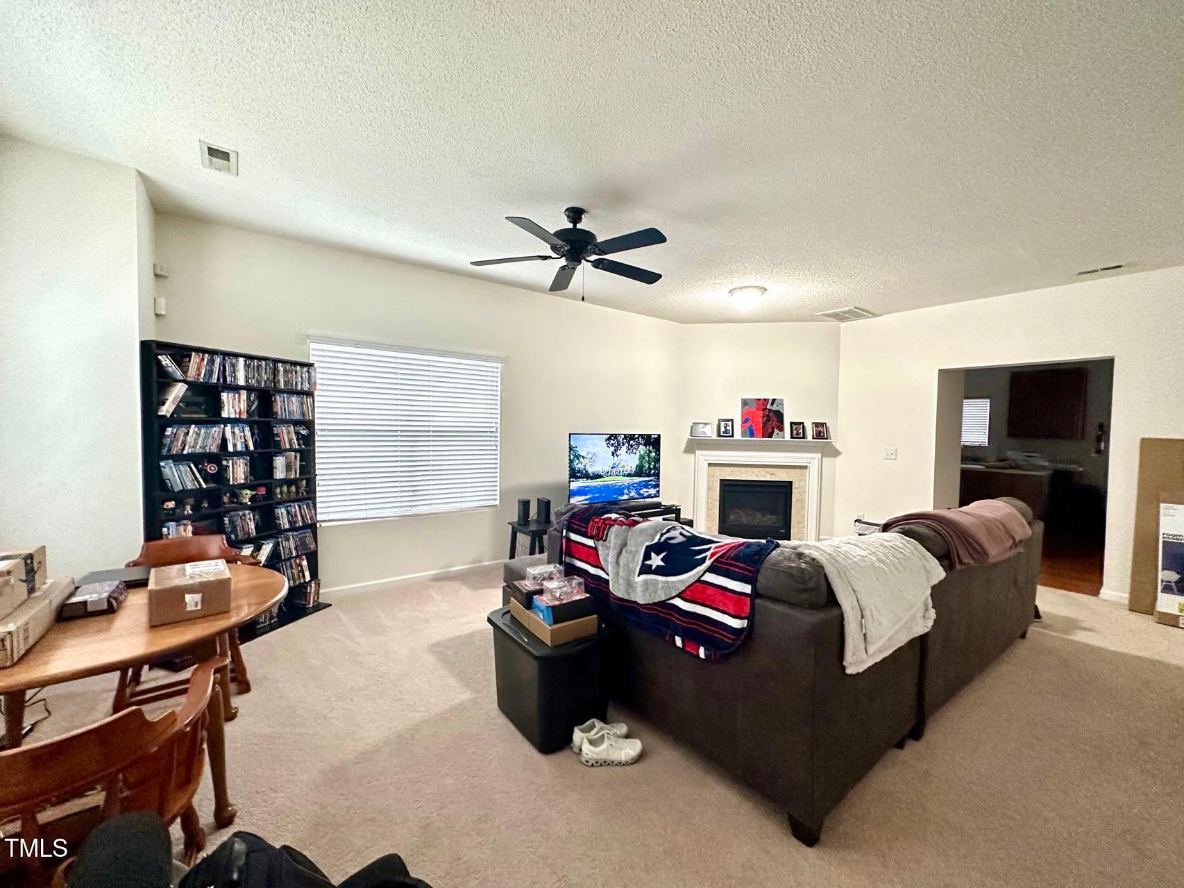 114 Graystar Road Apex, NC 27502 - Photo 4 of 14 a bedroom with furniture and a flat screen tv