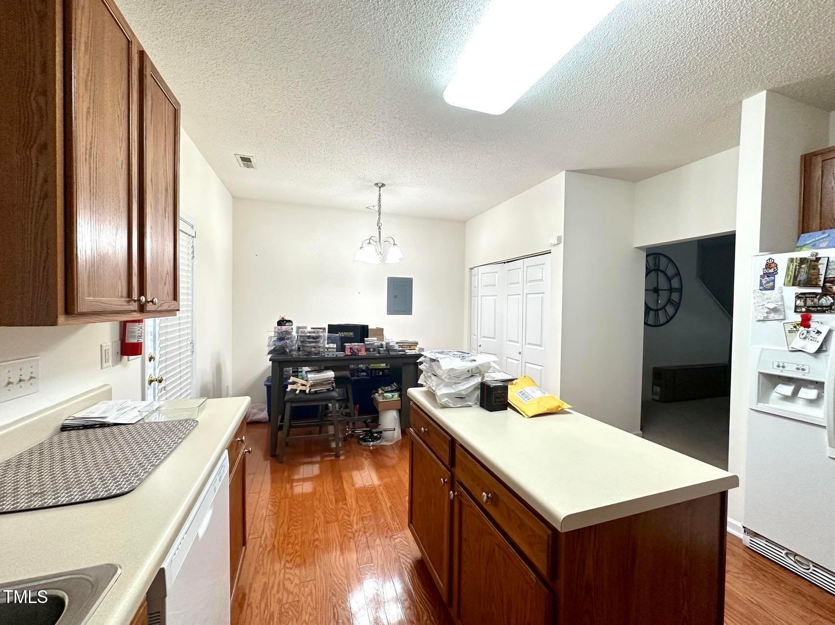 114 Graystar Road Apex, NC 27502 - Photo 5 of 14 a large kitchen with a table chairs stove and refrigerator