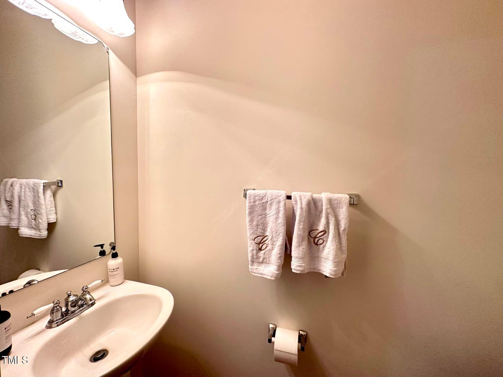 114 Graystar Road Apex, NC 27502 - Photo 7 of 14 a bathroom with a sink and mirror