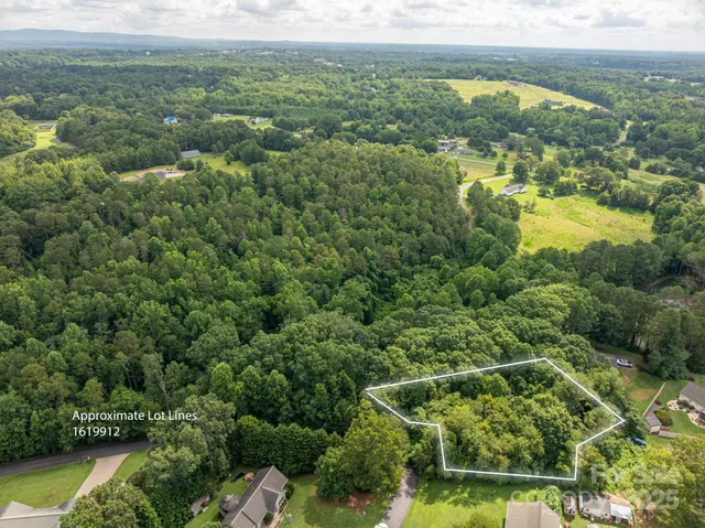 an aerial view of residential houses with outdoor space and swimming pool