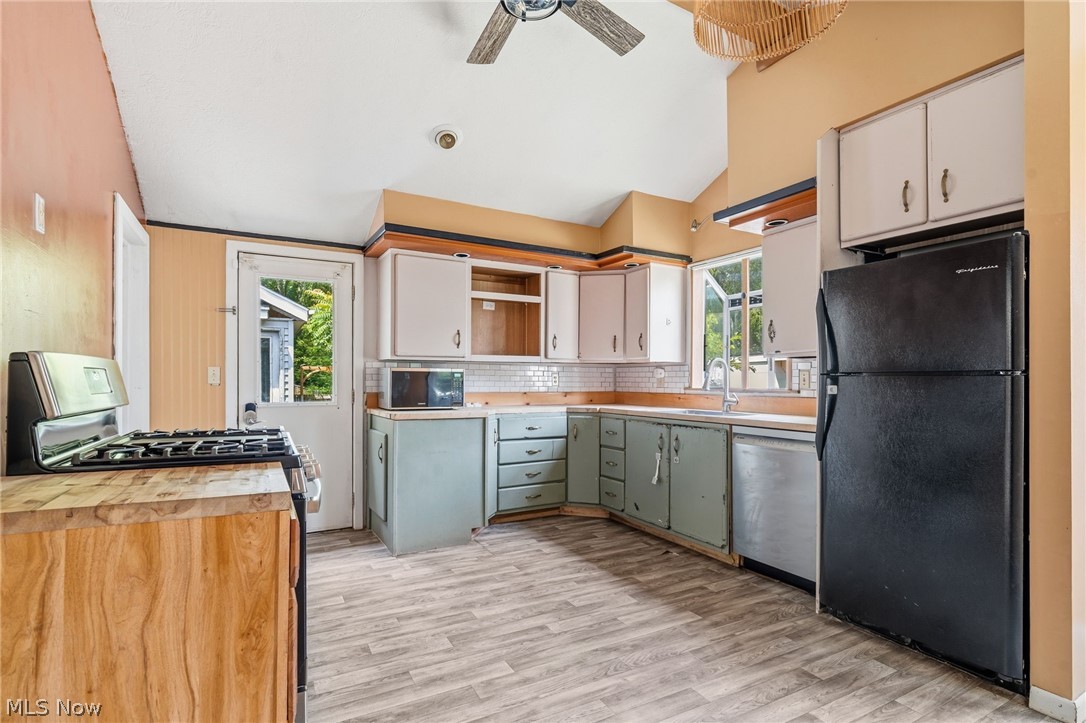 4449 18th Street Northwest Canton, OH 44708 - Photo 8 of 25 Kitchen featuring wood-finish flooring, vaulted ceilings, and a combination of light and dark cabinetry