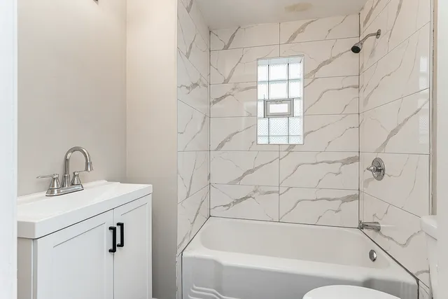 a bathroom with a bathtub and shower