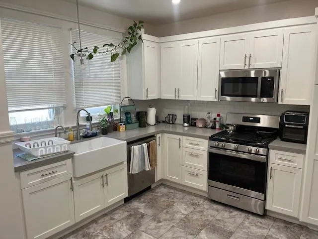 a kitchen with a white cabinets and white appliances