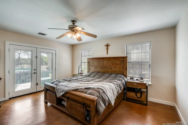 a bedroom with a bed and wooden floor