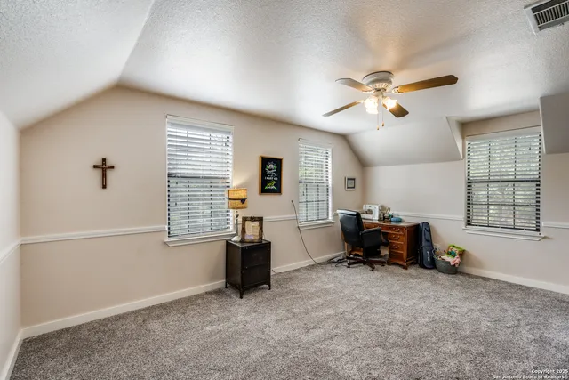 a view of workspace with furniture and window
