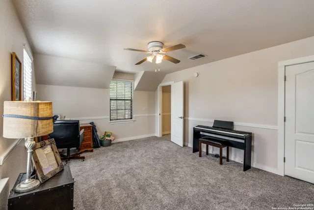 a view of a workspace with furniture and a window