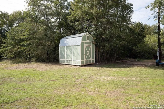 a view of a pool with a trees in the background