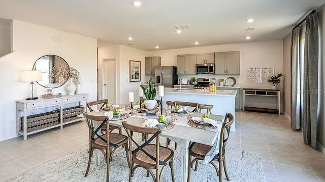 a living room with furniture and a view of kitchen