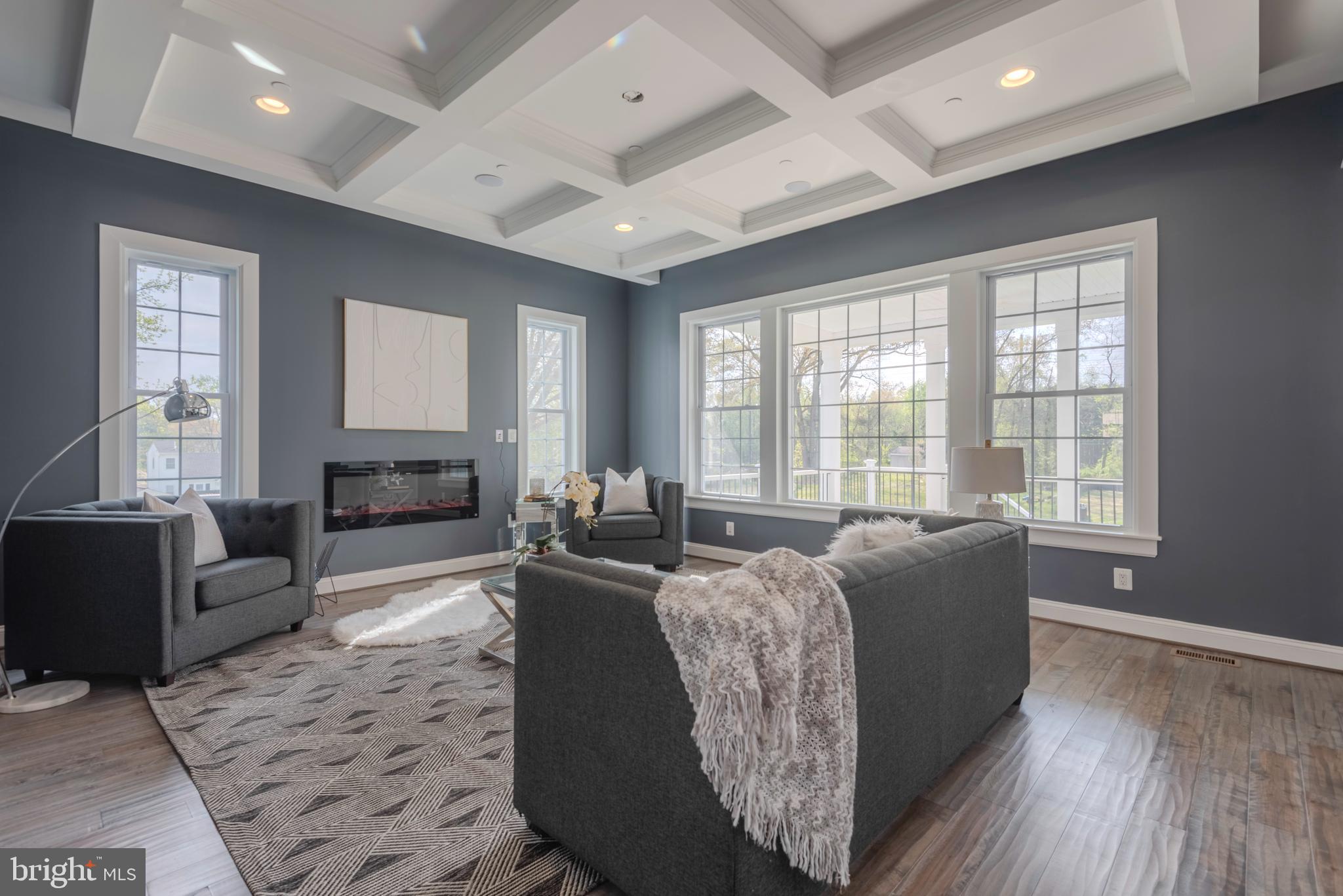 12603 Lanham Severn Road Bowie, MD 20720 - Photo 13 of 79 a living room with furniture large window and wooden floor