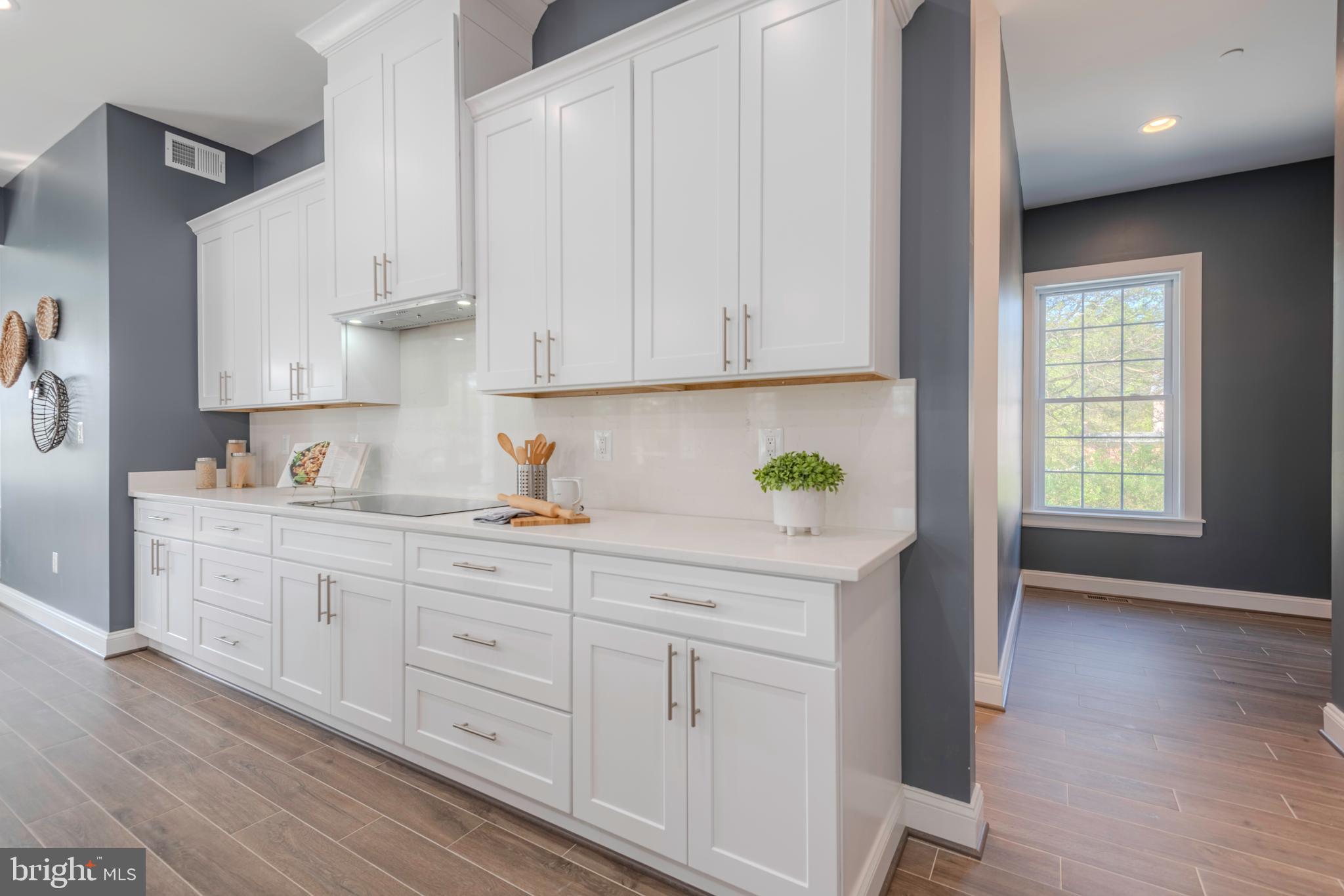 12603 Lanham Severn Road Bowie, MD 20720 - Photo 23 of 79 a kitchen with granite countertop white cabinets and white appliances