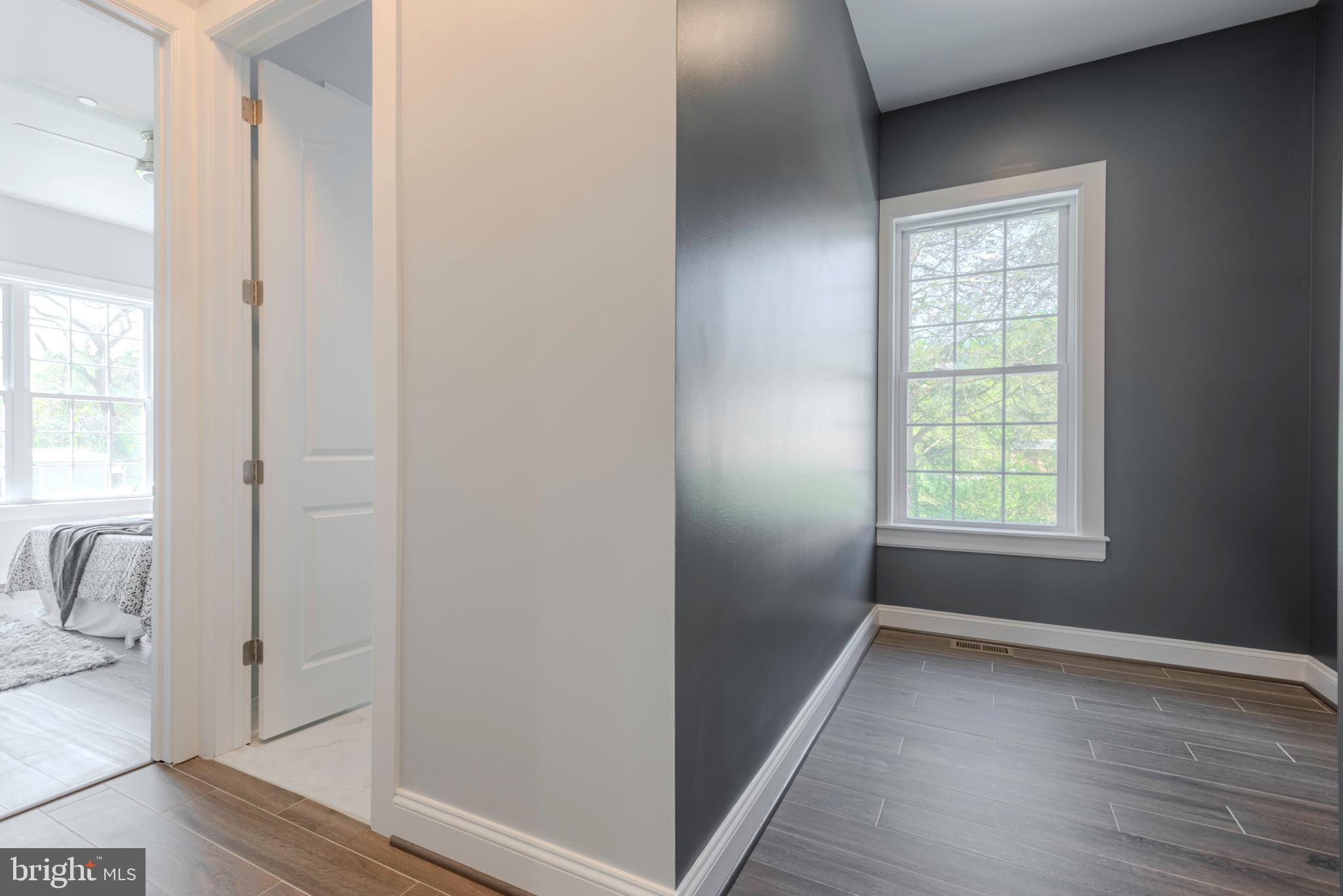 12603 Lanham Severn Road Bowie, MD 20720 - Photo 31 of 79 a view of hallway with window and wooden floor
