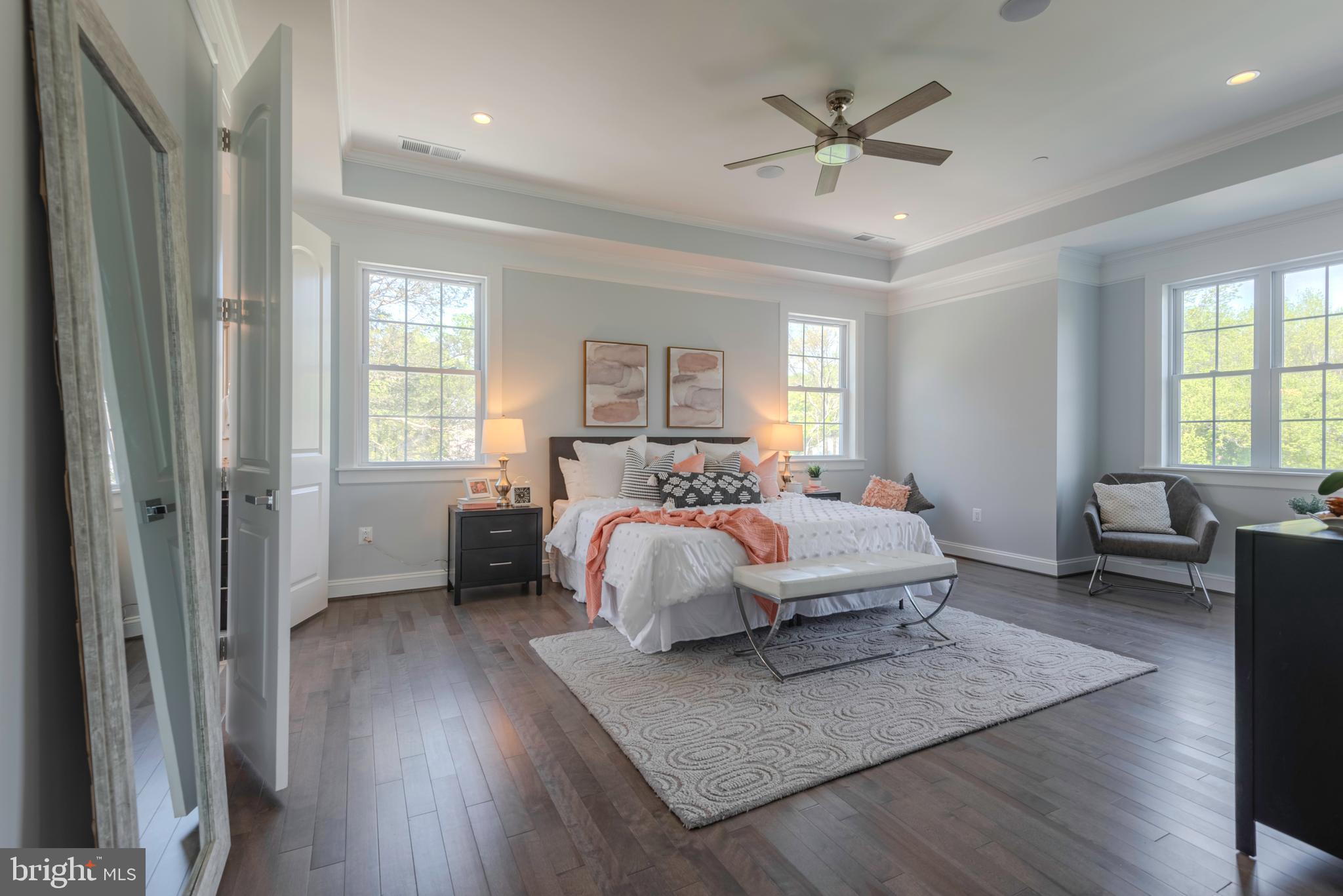 12603 Lanham Severn Road Bowie, MD 20720 - Photo 37 of 79 a spacious bedroom with a bed a table and a chandelier