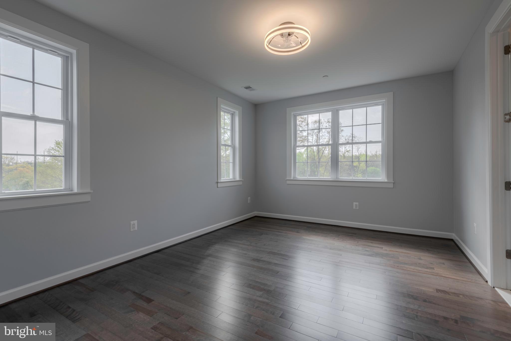 12603 Lanham Severn Road Bowie, MD 20720 - Photo 50 of 79 an empty room with wooden floor and windows