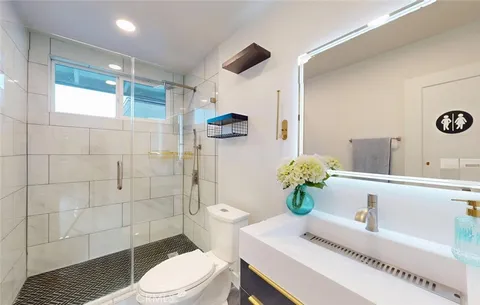 a spacious bedroom with a bed and a view of bathroom