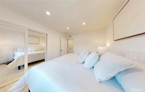 a bedroom with a large bed and a large window