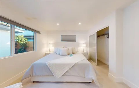 a spacious bathroom with a toilet sink and mirror